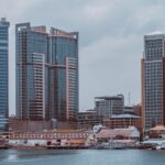 a city skyline with buildings and a body of water