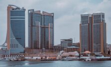 a city skyline with buildings and a body of water