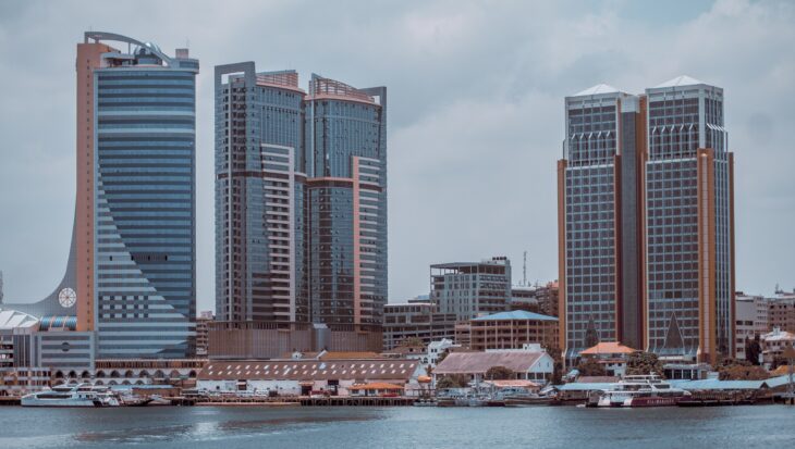 a city skyline with buildings and a body of water