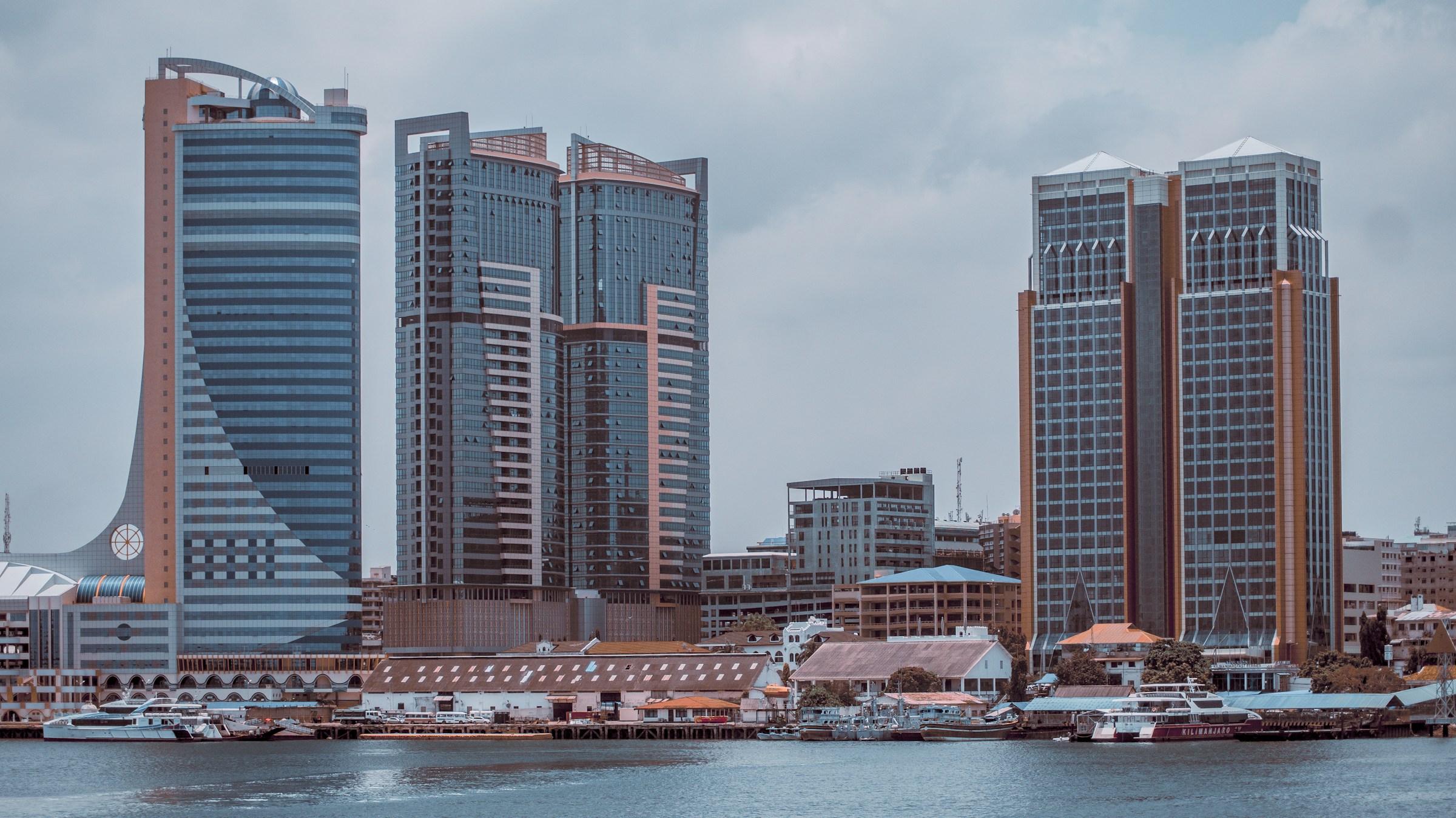 a city skyline with buildings and a body of water